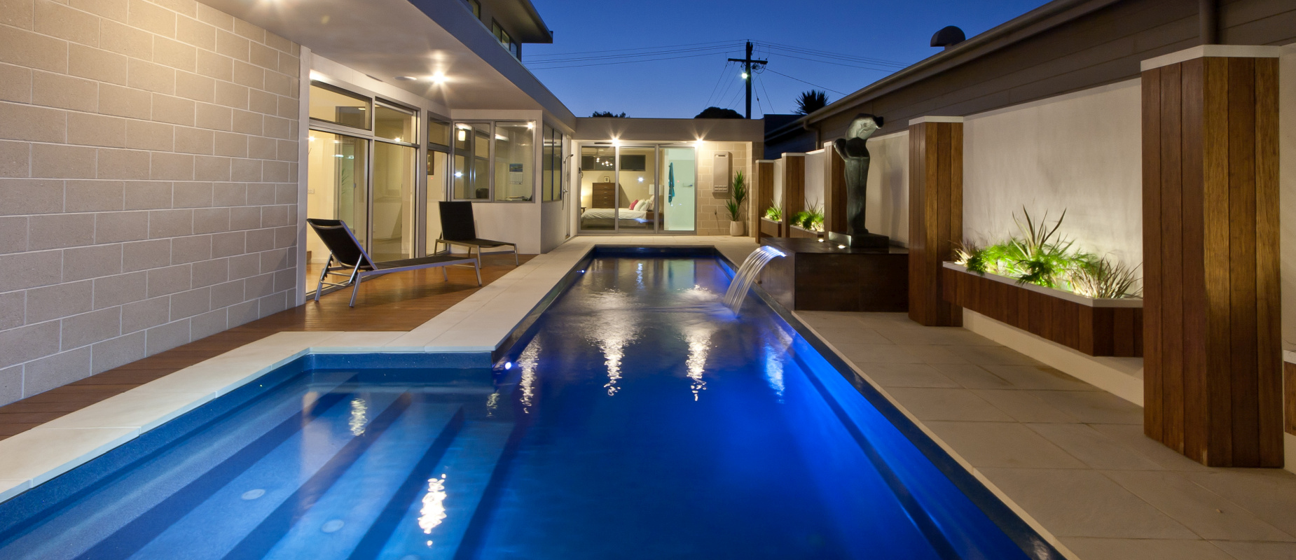 Compass-Pools-Australia_Fastlane-pool-for-swimming-laps-with-water-wall-feature-and-lights
